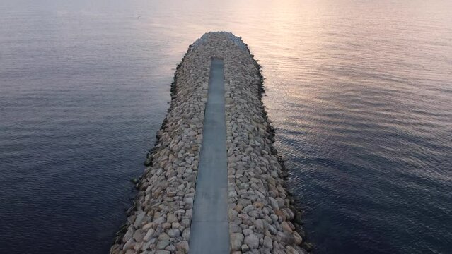 Aerial footage of a seaside stone pier at the Black Sea shore, Romania