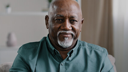 Close up African elderly grandfather posing at home. Portrait male business worker indoors in office company CEO old mature senior American man ethnic businessman looking at camera middle-aged boss