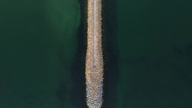 Aerial footage of a seaside stone pier at the Black Sea shore, Romania