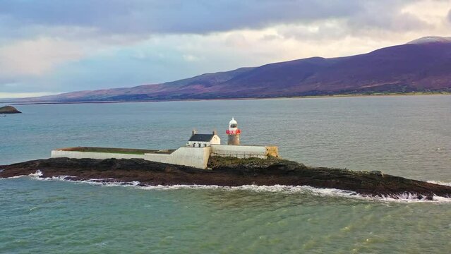 Aerial panorama view of the historic Fenit Lighthouse in Tralee Bay, beautiful clouds, sunset. High quality 4k footage