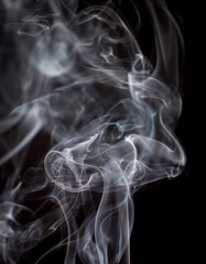 Abstract flash shot of smoke tendrils which lights the depth of the smoke perfectly. Background.