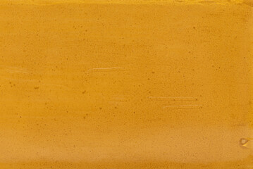 Yellow grunge surface of stone, with little bubbles and scratches on surface, background texture, copy space available