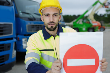 construction worker holding a sign