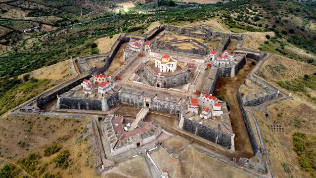 Aerial video zoom-out footage of the impressing star shaped fortress and landmark of Nossa Senhora da Graca in Elvas near the Spanish border, Portugal
