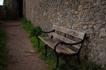 a teak hardwood wooden bench on the lawn in the UK winter
