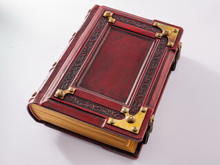 Vintage, medieval red leather book with embossed frame and metal corners lay down isolated