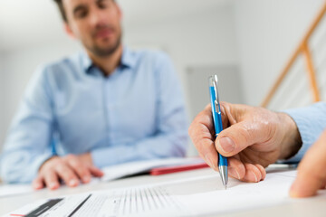 close up of hands signing official document