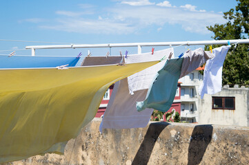 Laundry hanging on the clothes line, drying outdoors on the wind, in the old town center in Zadar,...