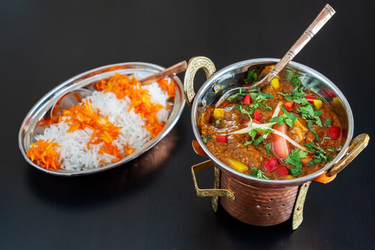 Indian chicken tikka masala curry with vegetables and sauce in a Baltic dish