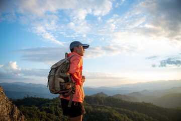Fototapeta na wymiar Successful hiker enjoy the view on mountain top cliff edge