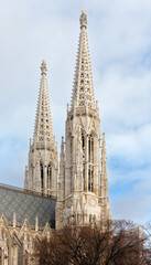 Fototapeta na wymiar The two bell towers of the Neo-gothic Votive Church in Vienna, Austria