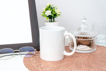 A white blank coffee mug on the top of a rounded mat decorated with minimalistic style