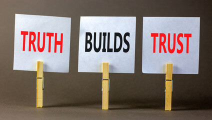 Truth builds trust symbol. Concept words Truth builds trust on white paper on clothespin on a beautiful grey table grey background. Business truth builds trust concept. Copy space.