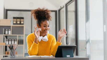 Pretty young african american student woman study online class in tablet video call zoom teacher learning english language experiment in knowledge-gathering from any location of their choice.