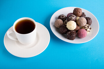 photo of a drink in a white cup and lots of colorful candy on a plate