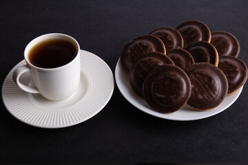 photo chocolate chip cookies beautifully arranged on a plate and a cup of coffee