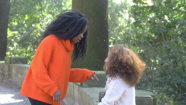 young African girl has an animated discussion with her friend