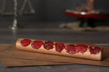 Seven seal scroll on old paper sheet with ancient balance scale and fire flames in the background....