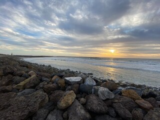 Fototapeta na wymiar Sunset over the shore rocks