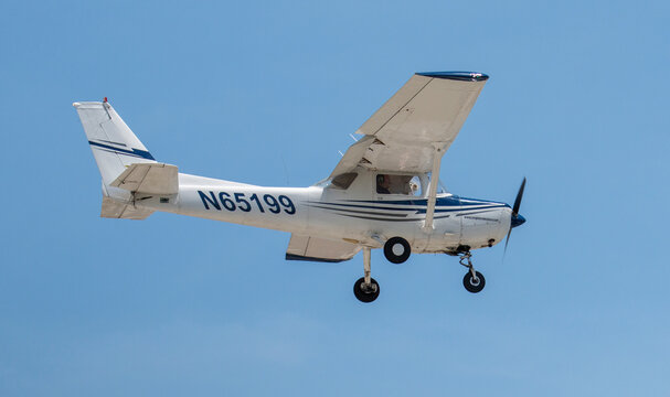 A Small Singile Engine Propeller Plane Flying With A Blue Sky Close Up