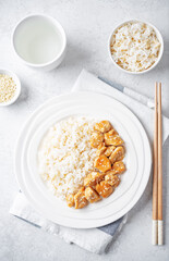 Orange teriyaki chicken with rice in a plate
