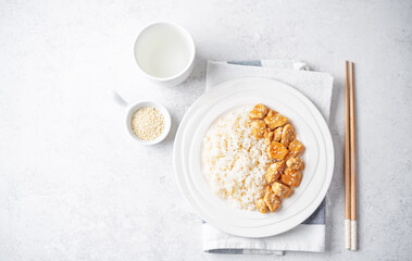 Orange teriyaki chicken with rice in a plate