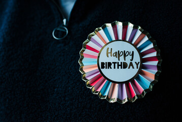 colourful happy birthday badge on clothing
