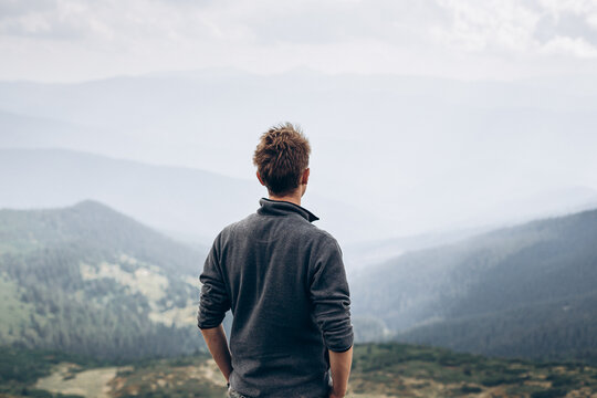 A man alone with himself in the middle of forested mountains