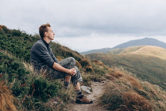 A man alone with himself in the middle of forested mountains
