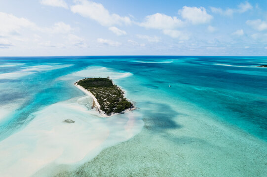 Aerial of Sailboat Next to Island in Turquoise Bahamas Water