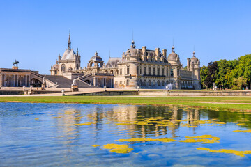 Chantilly, France. View of the Chateau de Chantilly from the garden. - obrazy, fototapety, plakaty