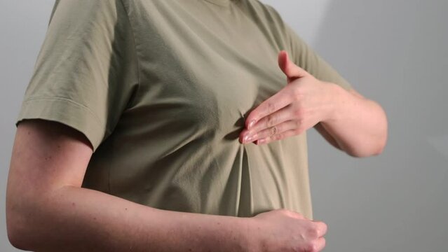 Breast cancer self-check. Hand examining, palpating chest for tumors, lumps, fibroadenoma. Women health awareness day