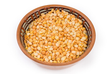 Raw yellow split peas in bowl on a white background