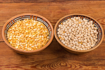 Raw yellow whole and split peas in the two bowls