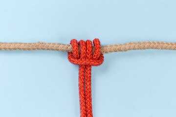 Rope Prusik knot on a blue background