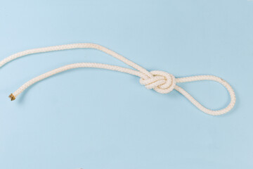 Rope knot as overhand loop on a blue background