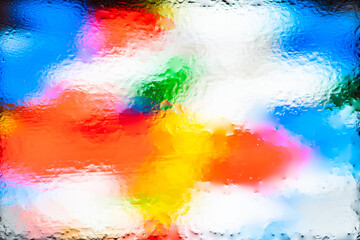 Fototapeta na wymiar Blurred abstract background. Abstract image of colored blurred spots through wet glass. Water drops