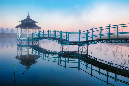 Gazebo on the lake. Morning fog, and dawn or sunset.