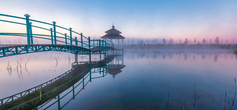 Gazebo on the lake. Morning fog, and dawn or sunset.