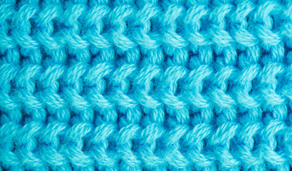 Background of knitted fabric with a pattern. Weaving winter clothes close-up.