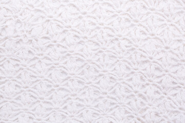 Background of knitted fabric with a pattern. Weaving winter clothes close-up.