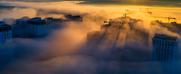 High-rise buildings in the morning autumn fog