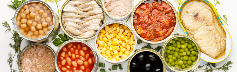 Wide background of canned food, processed fish and vegetables.