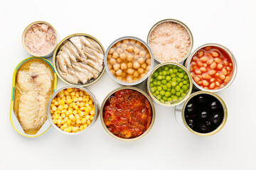 Processed vegetables and fish on a white background, canned food.