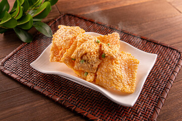 Golden crispy rice served dish isolated on wooden table top view of Hong Kong food