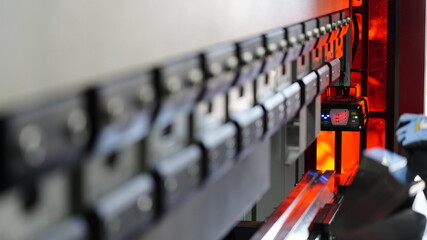 worker, pressing metal in press machine at factory    