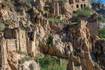 Ruins of abandoned residential buildings in the mountain village of Gamsutl. Dagestan, Russia