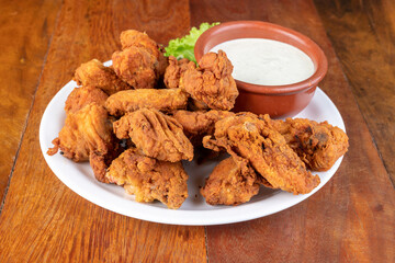 fried chicken with sauce, on wooden table