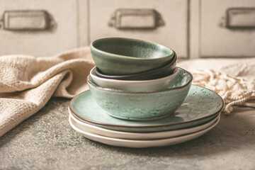 Gray stoneware plates and bowls on a rustic table