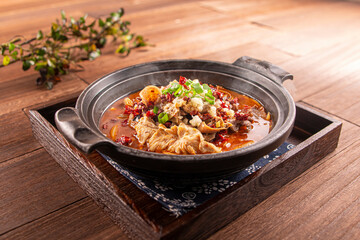 Spicy beer beef offal pot served dish isolated on wooden table top view of Hong Kong food